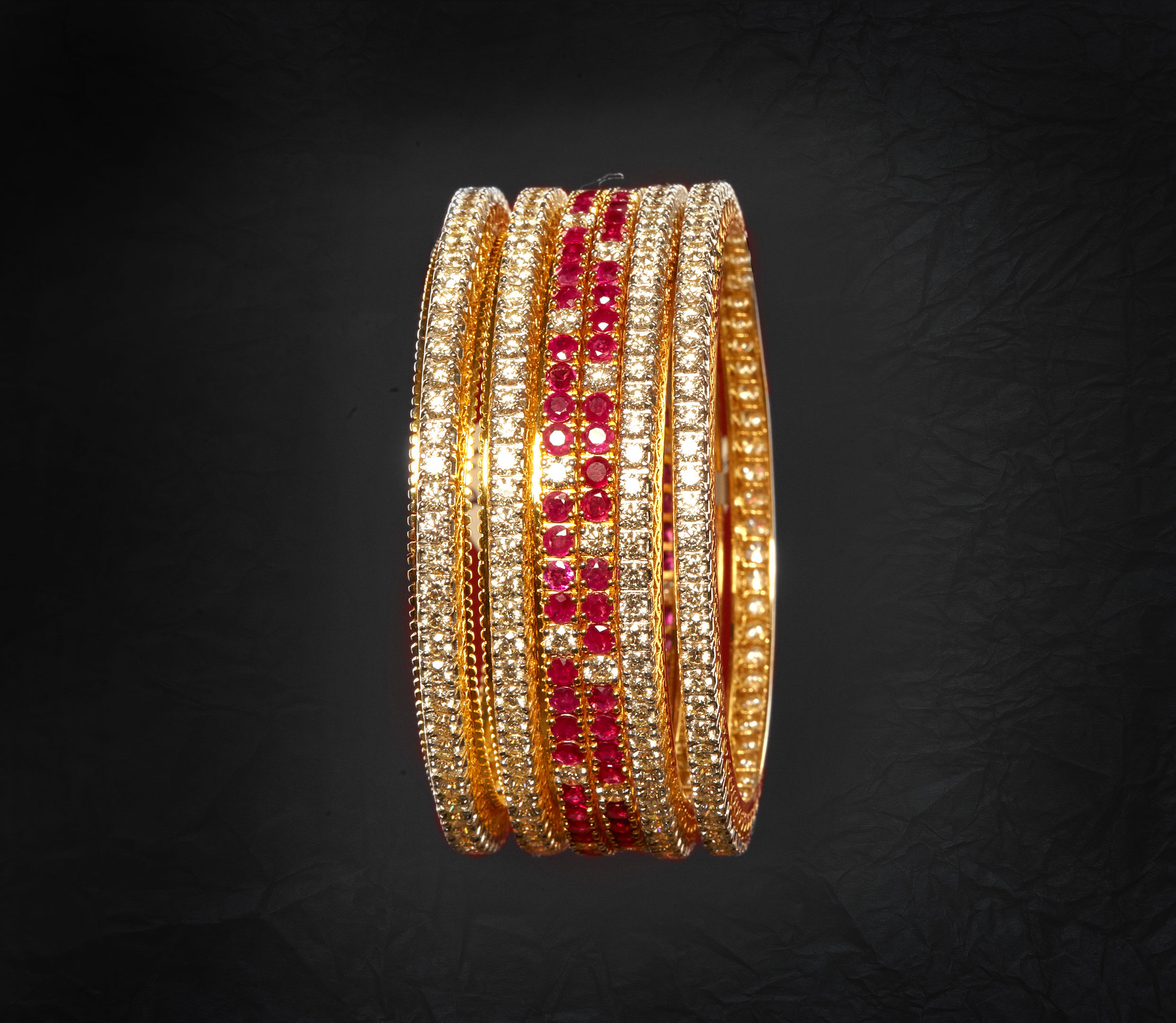 ‘Bangle’ makes you look traditional. So why not choose single line diamond studded bangle
conjoining it with ruby studded diamond bangle.