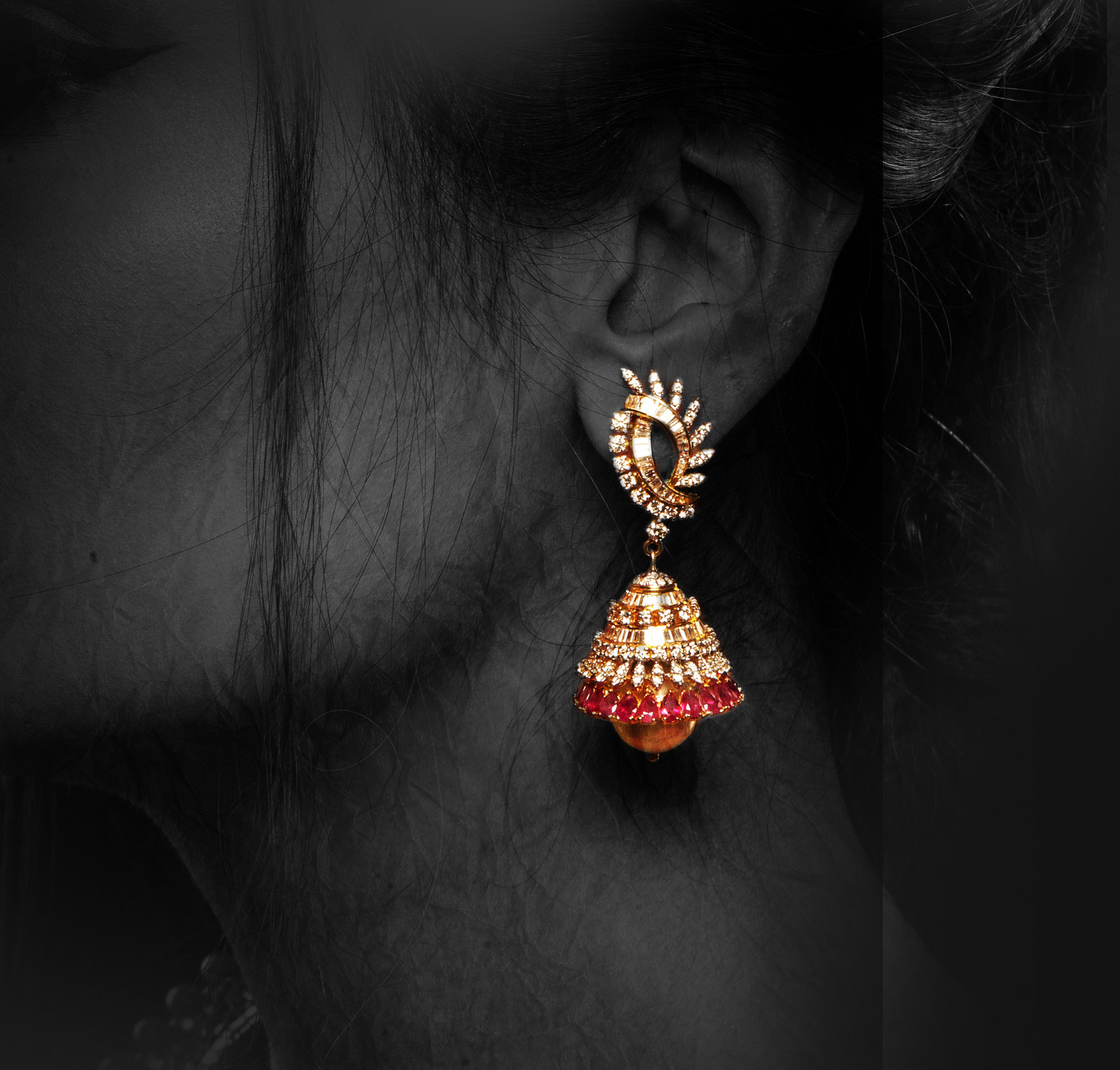 Multiply your charm with this real rubies studded round and bugged shaped diamond jhumkas
and these south sea pearls in the bottom gives it a killing look.